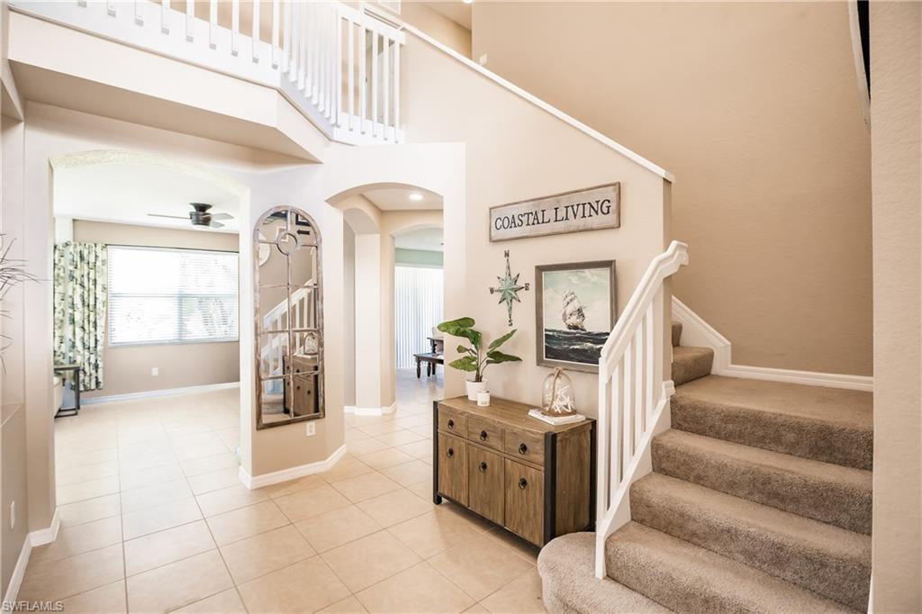 2104 Par Drive Naples, FL 34120 - Photo 2 of 26 a view of hallway with stairs and furniture