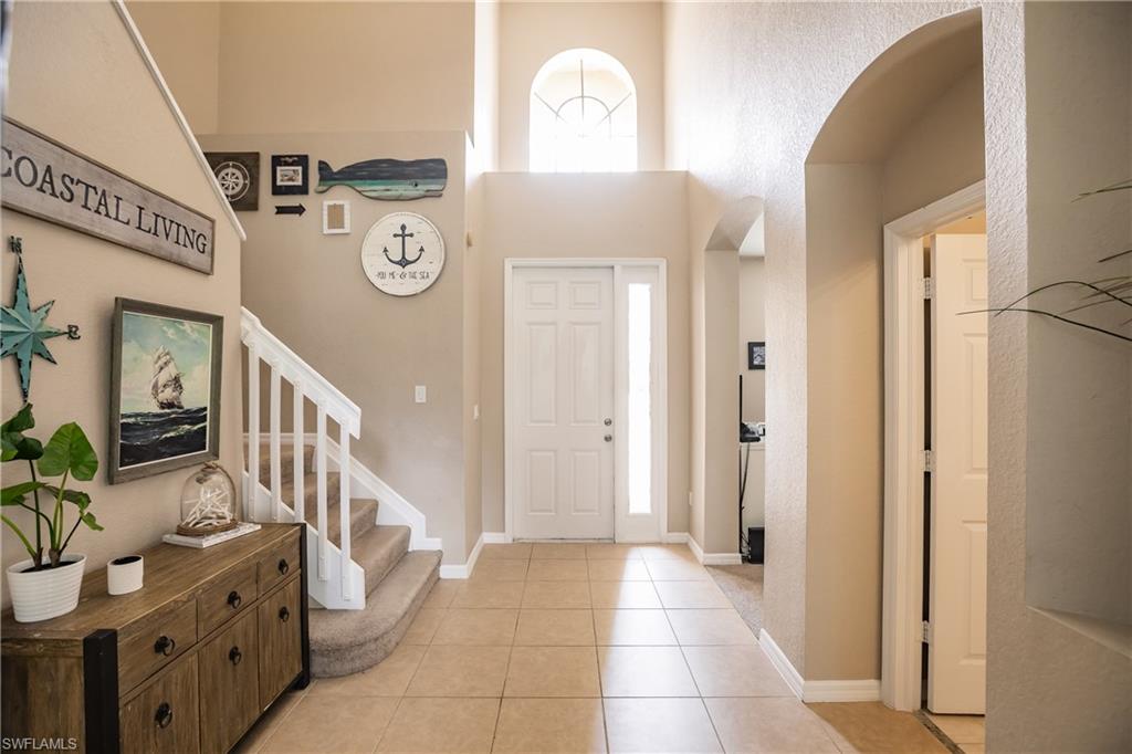 2104 Par Drive Naples, FL 34120 - Photo 3 of 26 a view of an entryway with wooden floor