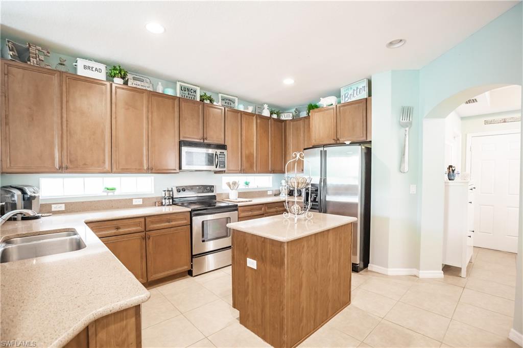 2104 Par Drive Naples, FL 34120 - Photo 9 of 26 a kitchen with stainless steel appliances granite countertop a sink stove and refrigerator