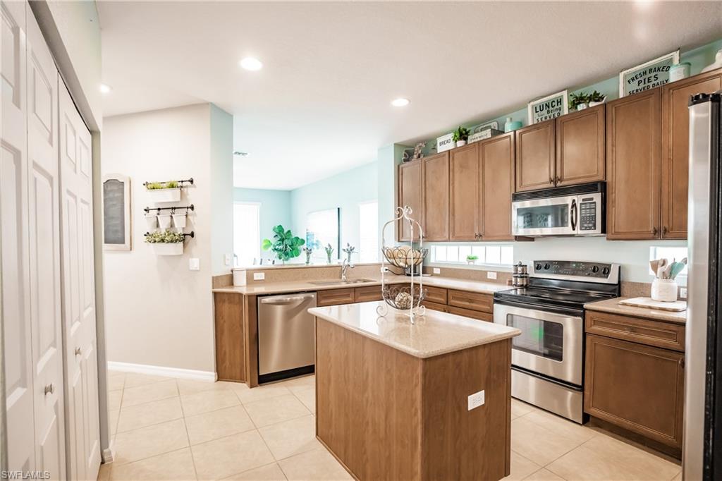 2104 Par Drive Naples, FL 34120 - Photo 10 of 26 a kitchen with a sink stove and refrigerator