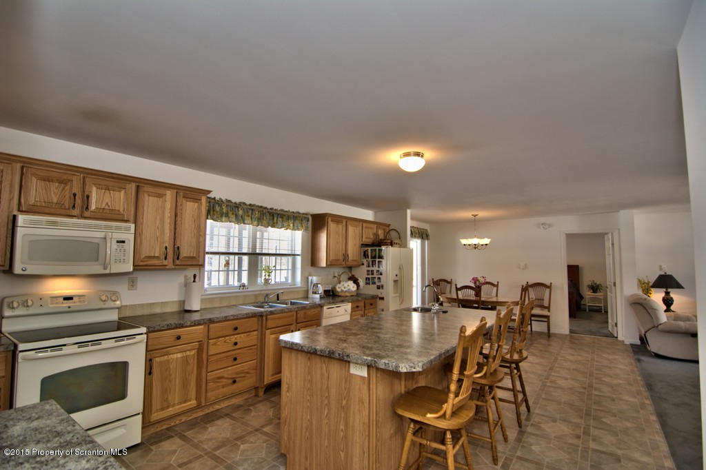 2744 Boulder Road Lake Ariel, PA 18436 - Photo 25 of 47 a kitchen with stainless steel appliances granite countertop a stove a sink a refrigerator and chairs