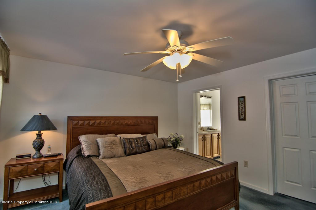 2744 Boulder Road Lake Ariel, PA 18436 - Photo 34 of 47 a bedroom with a bed and a chandelier