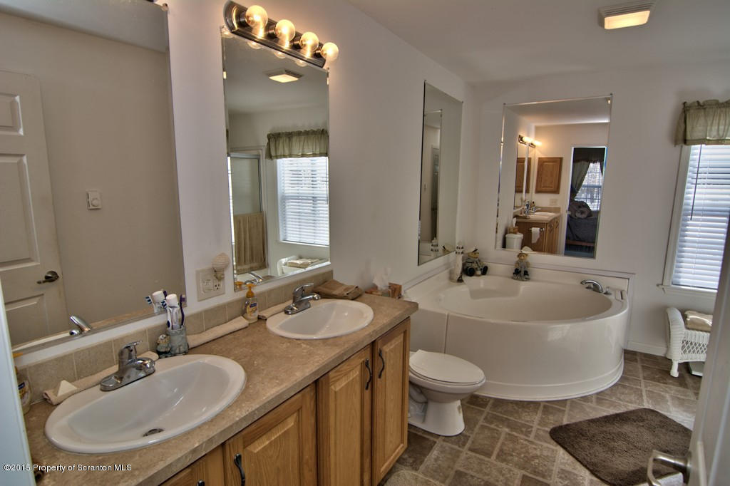 2744 Boulder Road Lake Ariel, PA 18436 - Photo 36 of 47 a bathroom with a double vanity sink a mirror and a toilet