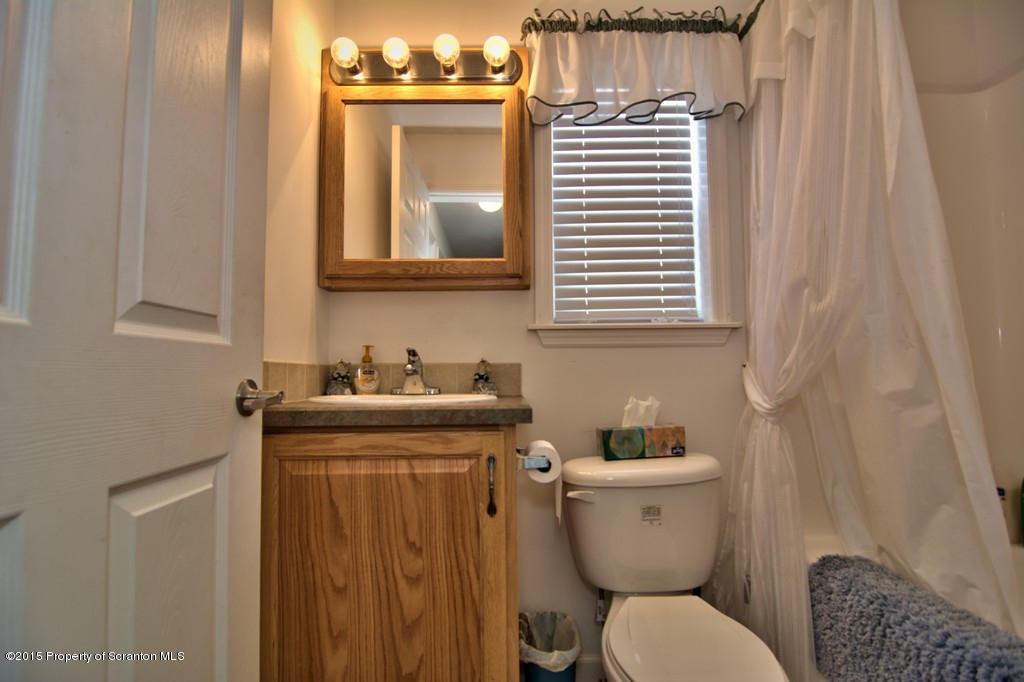 2744 Boulder Road Lake Ariel, PA 18436 - Photo 43 of 47 a bathroom with a toilet a sink and mirror