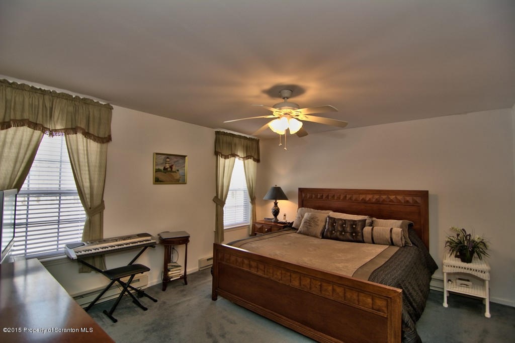 2744 Boulder Road Lake Ariel, PA 18436 - Photo 10 of 47 a bedroom with a bed and a chandelier