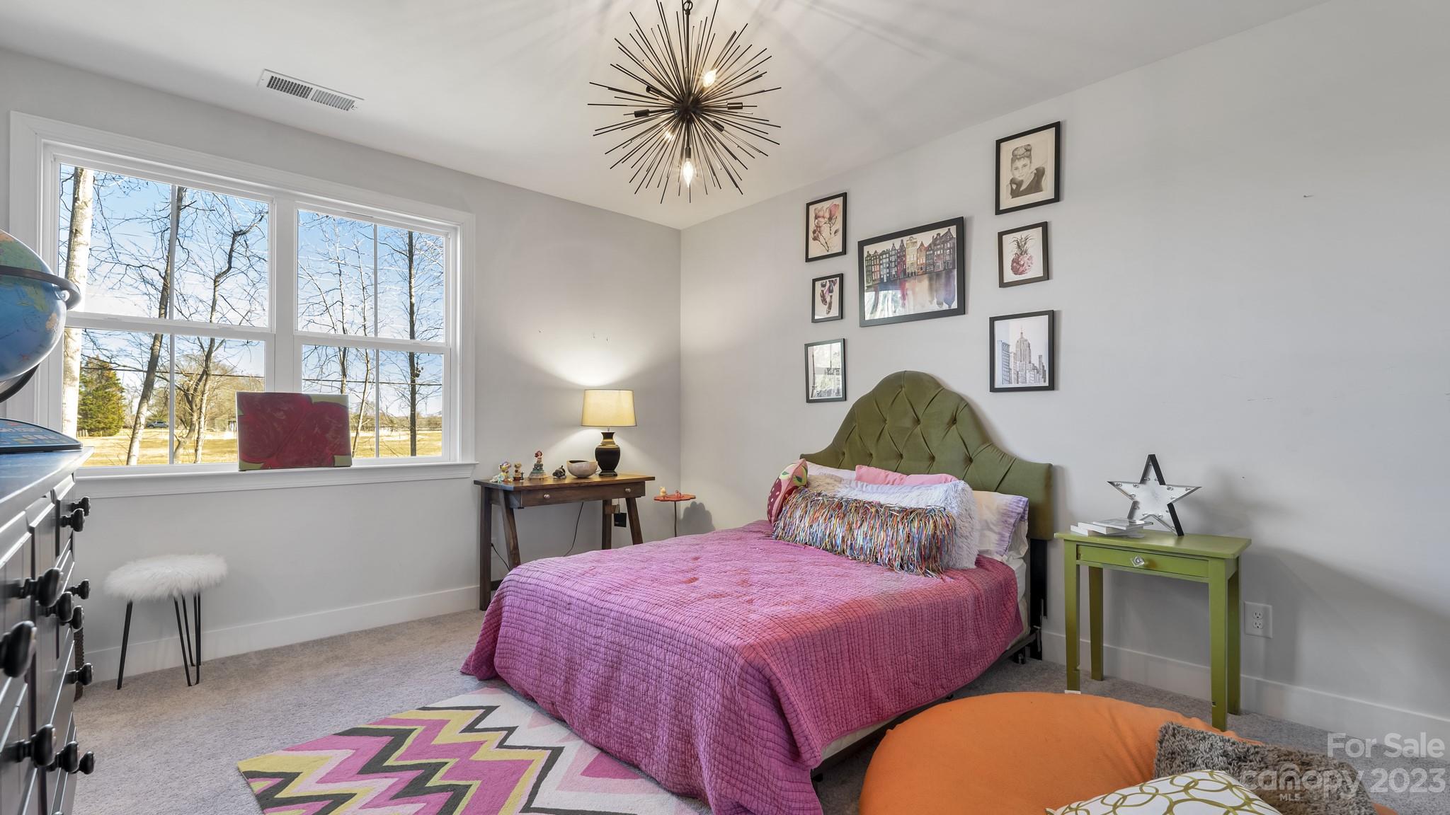 5351 Fewell Road Clover, SC 29710 - Photo 18 of 27 a bedroom with a bed and a painting on the wall