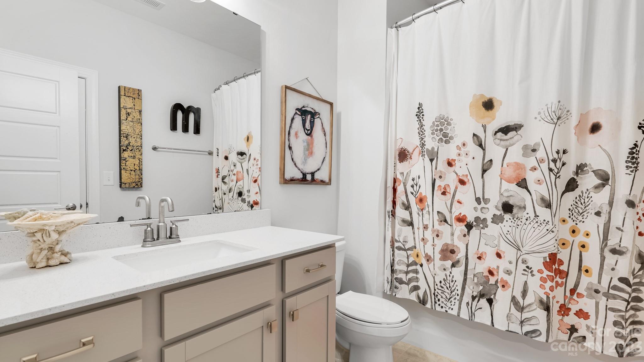 5351 Fewell Road Clover, SC 29710 - Photo 19 of 27 a bathroom with a granite countertop sink a toilet and a mirror