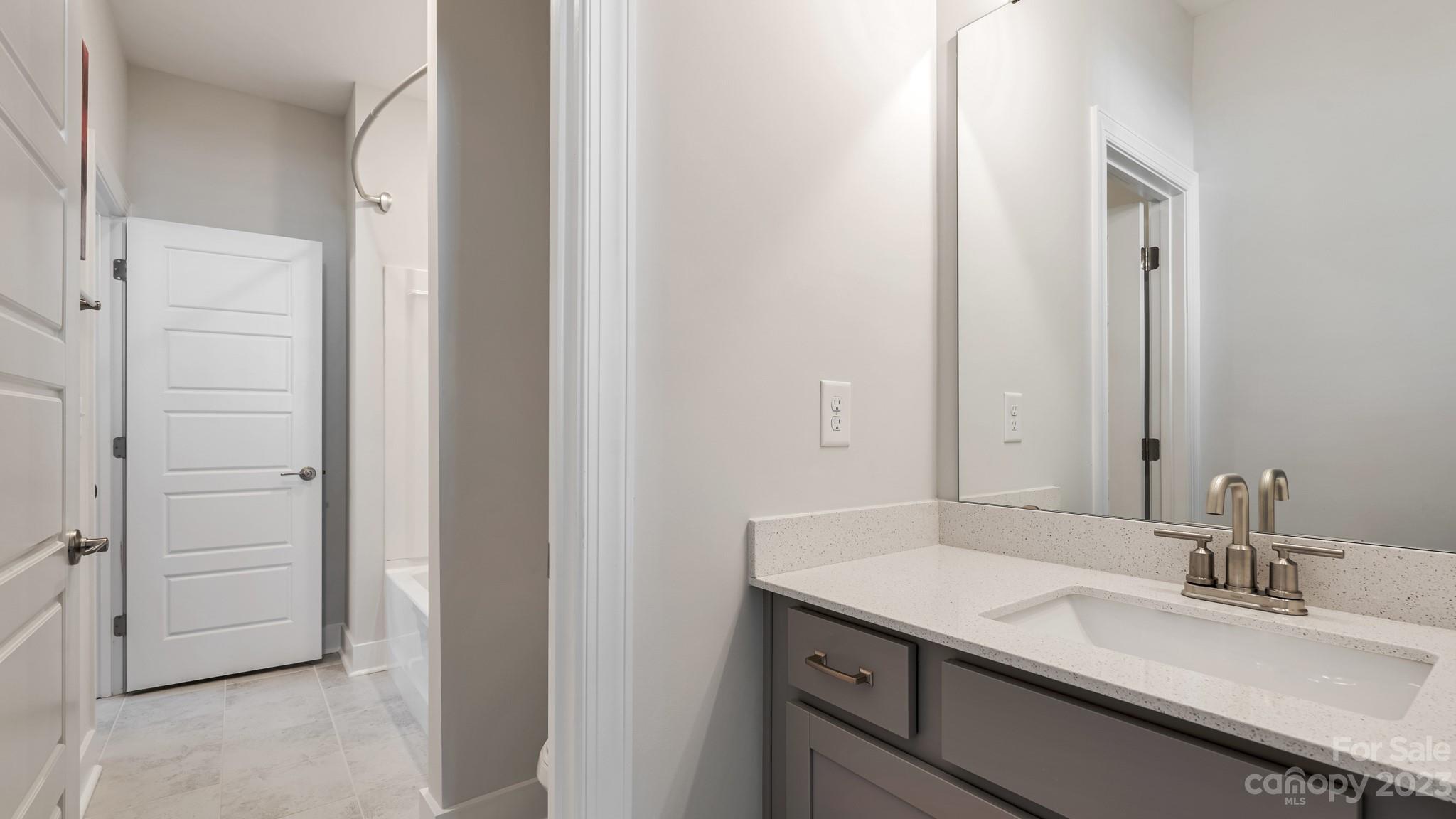 5351 Fewell Road Clover, SC 29710 - Photo 22 of 27 a bathroom with a granite countertop sink and a mirror