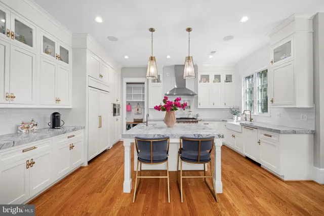 a large kitchen with a table and chairs
