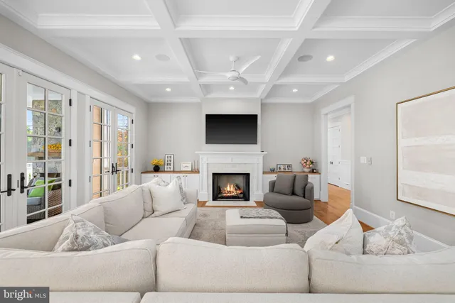 a living room with furniture a fireplace and a large window