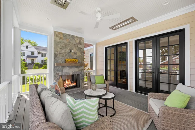 a living room with furniture a fireplace and a floor to ceiling window