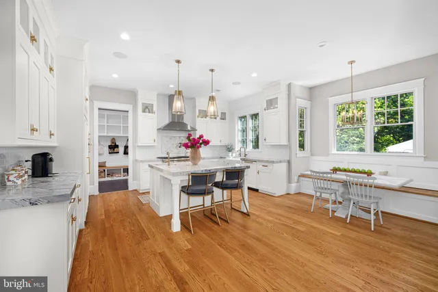 a kitchen with stainless steel appliances granite countertop a stove a sink dishwasher and a dining table with kitchen countertops