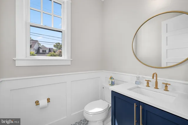 a bathroom with a sink a toilet and a mirror