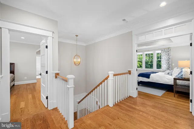 a view of a bedroom with furniture window and wooden floor