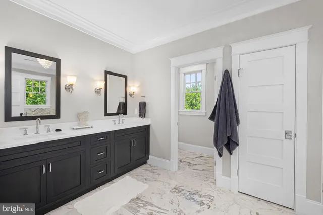 a bathroom with a double vanity sink and mirror