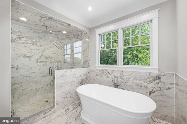 a bathroom with a bathtub and window