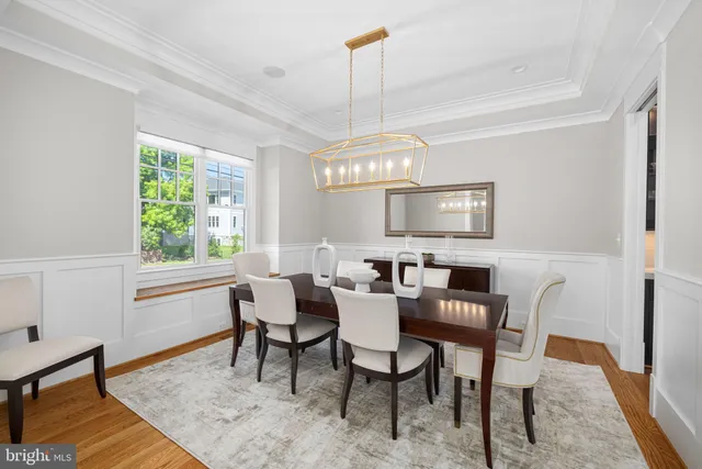 a view of a a dining room with furniture window and wooden floor
