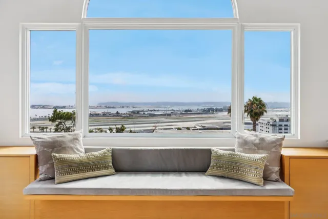 a living room with furniture and a floor to ceiling window