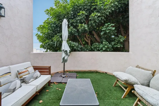 a living room with furniture a ceiling fan and a rug