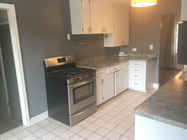 45 Bradley Lane Hoffman Estates, IL 60169 - Photo 2 of 12 a kitchen with granite countertop white cabinets and white appliances