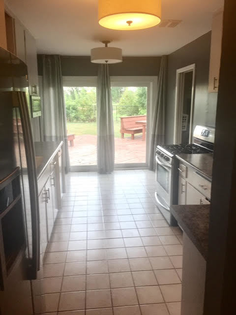45 Bradley Lane Hoffman Estates, IL 60169 - Photo 3 of 12 a view of a refrigerator in kitchen and an empty room