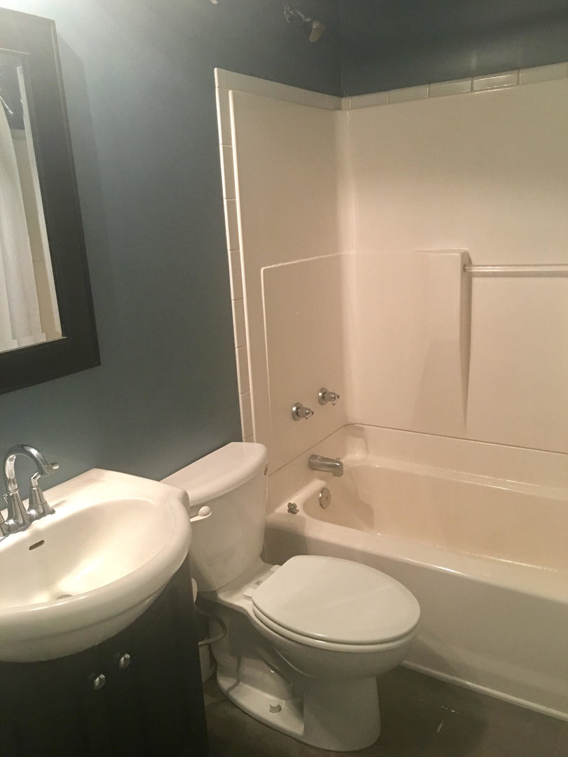 45 Bradley Lane Hoffman Estates, IL 60169 - Photo 5 of 12 a bathroom with a sink a toilet and shower