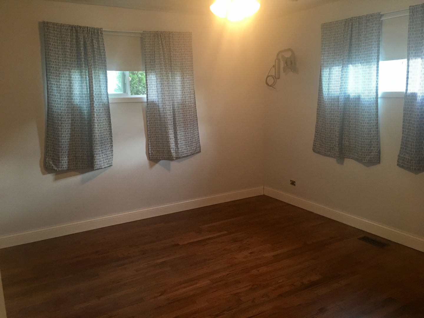 45 Bradley Lane Hoffman Estates, IL 60169 - Photo 8 of 12 a view of a room with wooden floor and windows