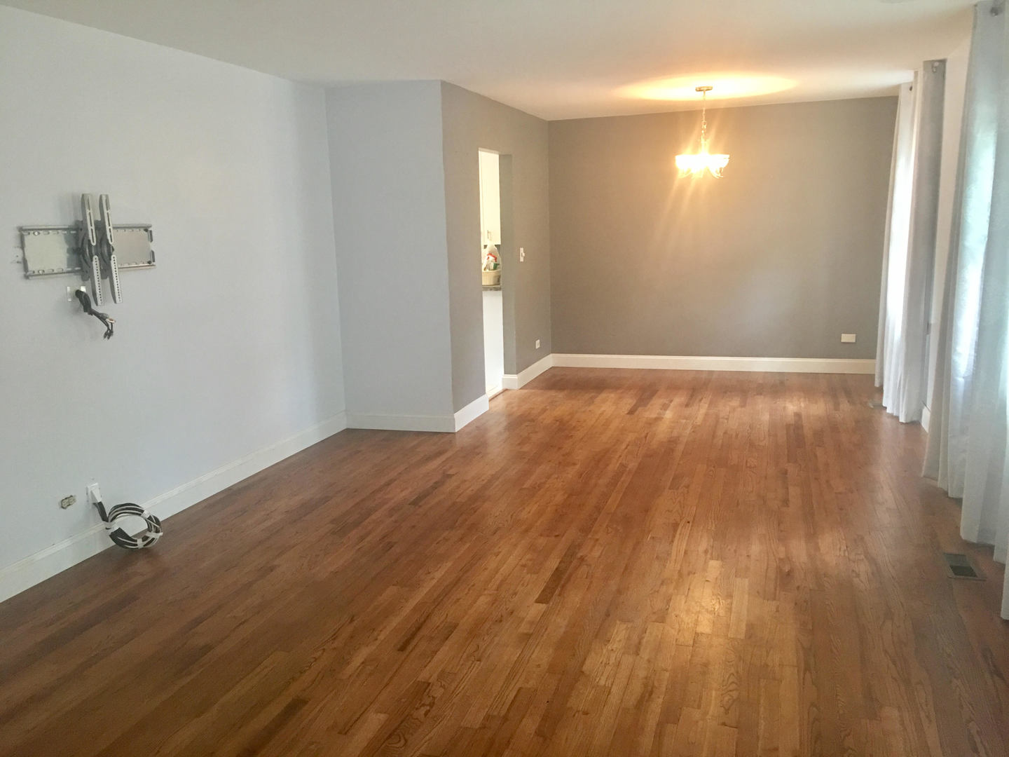 45 Bradley Lane Hoffman Estates, IL 60169 - Photo 10 of 12 a view of empty room with wooden floor and fan