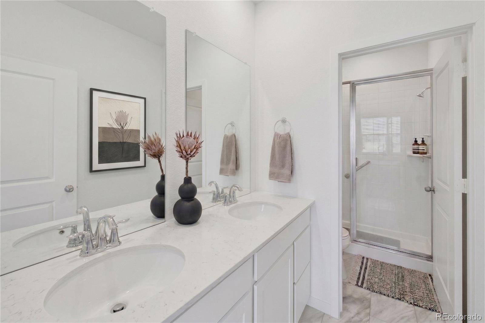 1964 South Gold Bug Way Aurora, CO 80018 - Photo 6 of 15 a bathroom with double vanity sinks and a mirror