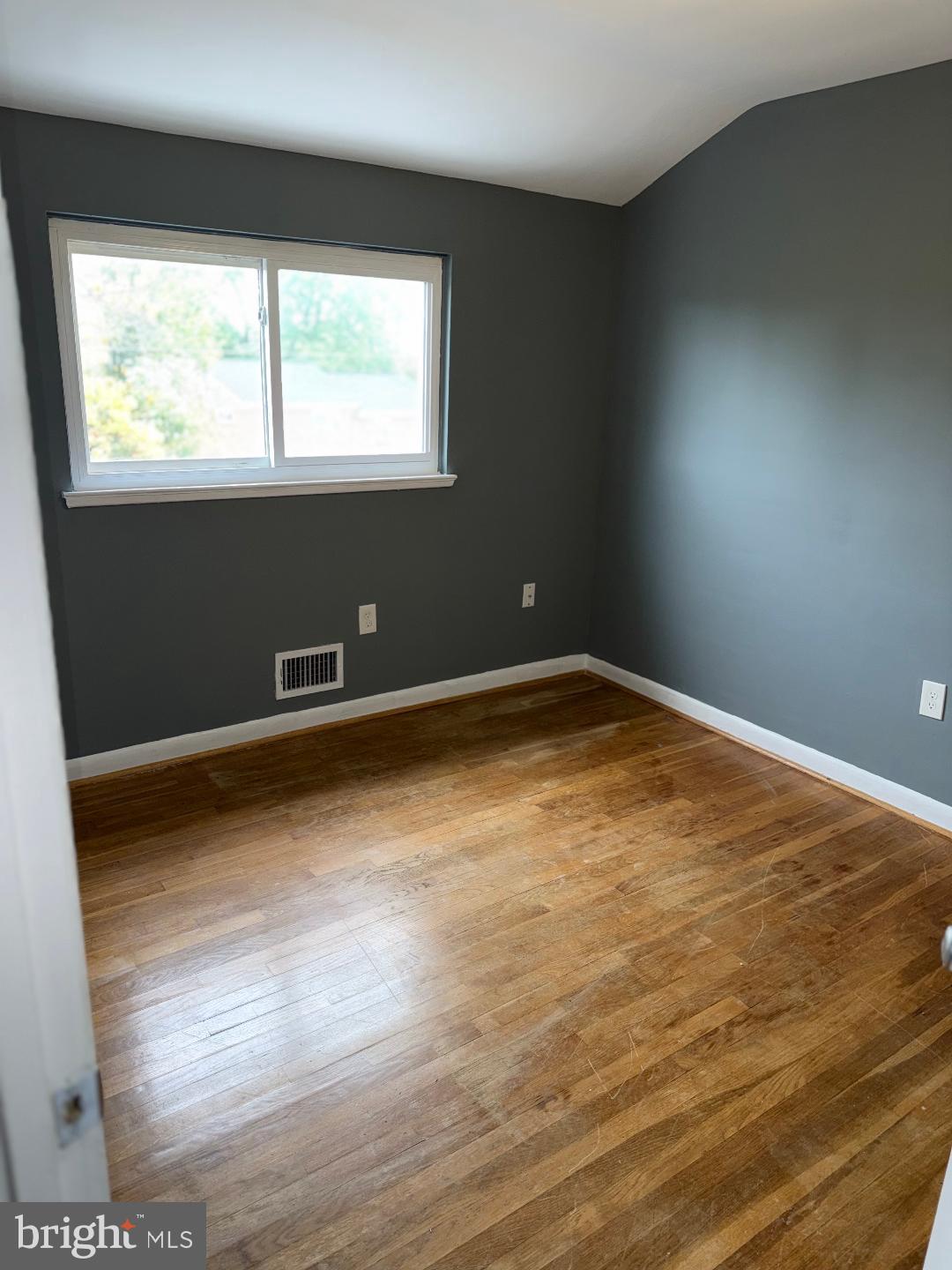 645 Queensgate Road Baltimore, MD 21229 - Photo 13 of 21 an empty room with wooden floor and windows