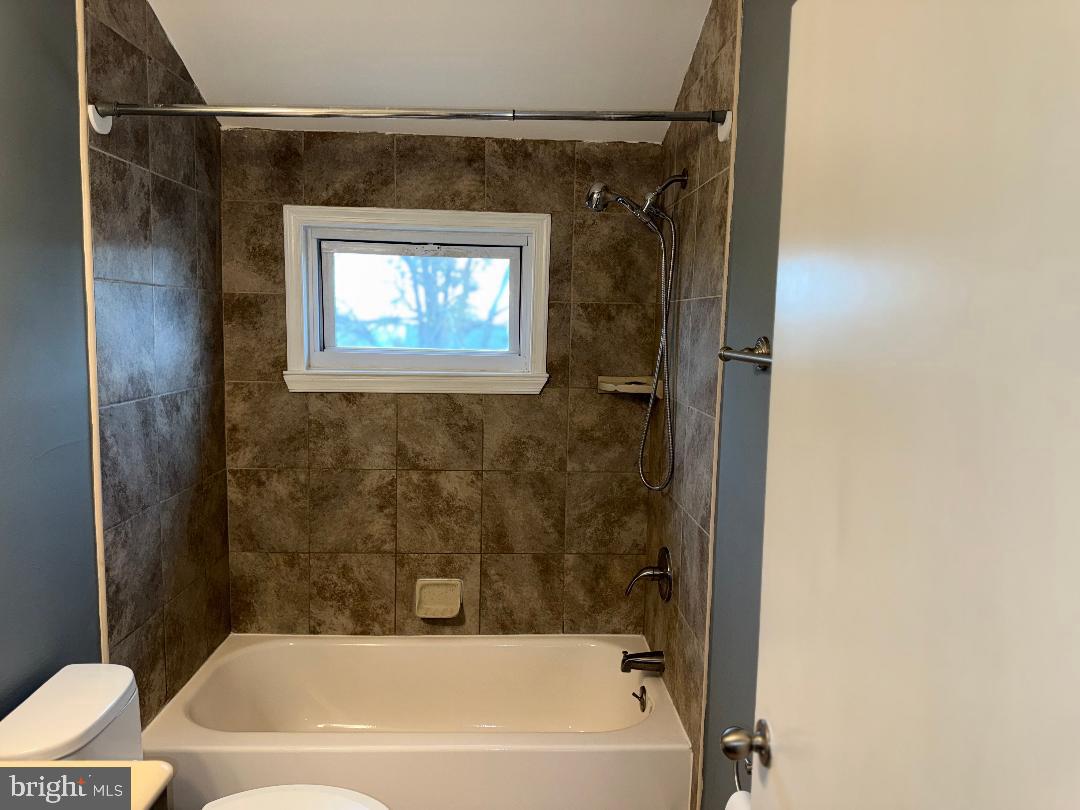 645 Queensgate Road Baltimore, MD 21229 - Photo 16 of 21 a bathroom with a bathtub and a shower
