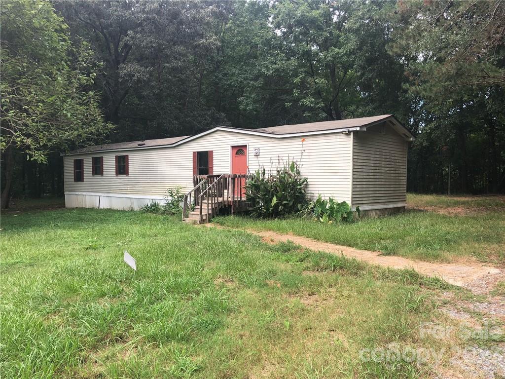 1240 Woodridge Road, Unit 6 Clover, SC 29710 - Photo 1 of 20 a view of a backyard with plants and large tree