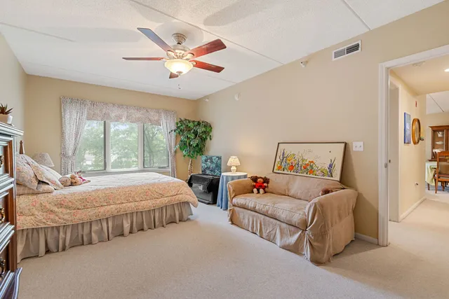 a bedroom with two beds and windows