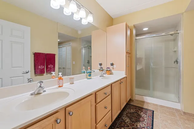 a bathroom with double vanity sink and a mirror