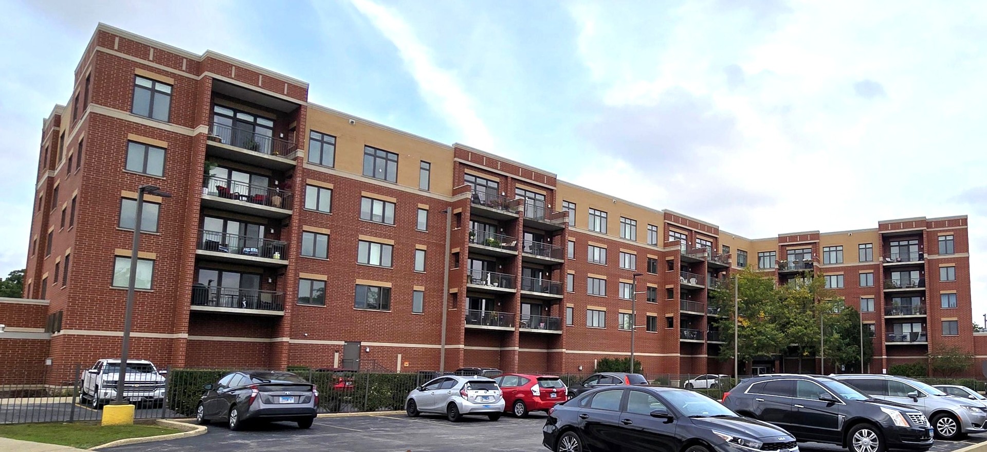 225 Main Street, Unit 201 Roselle, IL 60172 - Photo 21 of 21 a front view of a building with lot of cars parked