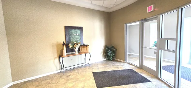 a view of a hallway view with wooden floor and a living room