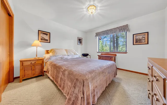 a bedroom with bed and window