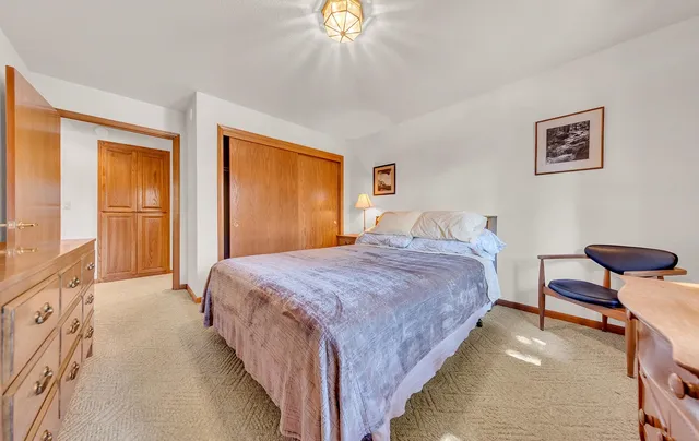 a bedroom with bed and a window