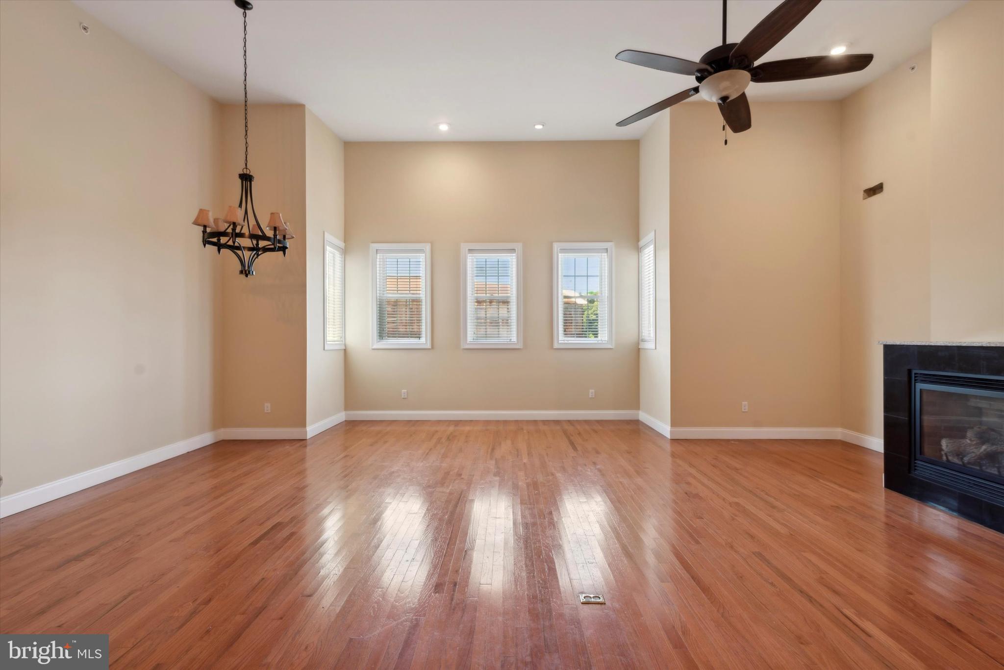4151 Cresson Street, Unit 3F Philadelphia, PA 19127 - Photo 3 of 15 an empty room with wooden floor a ceiling fan and windows