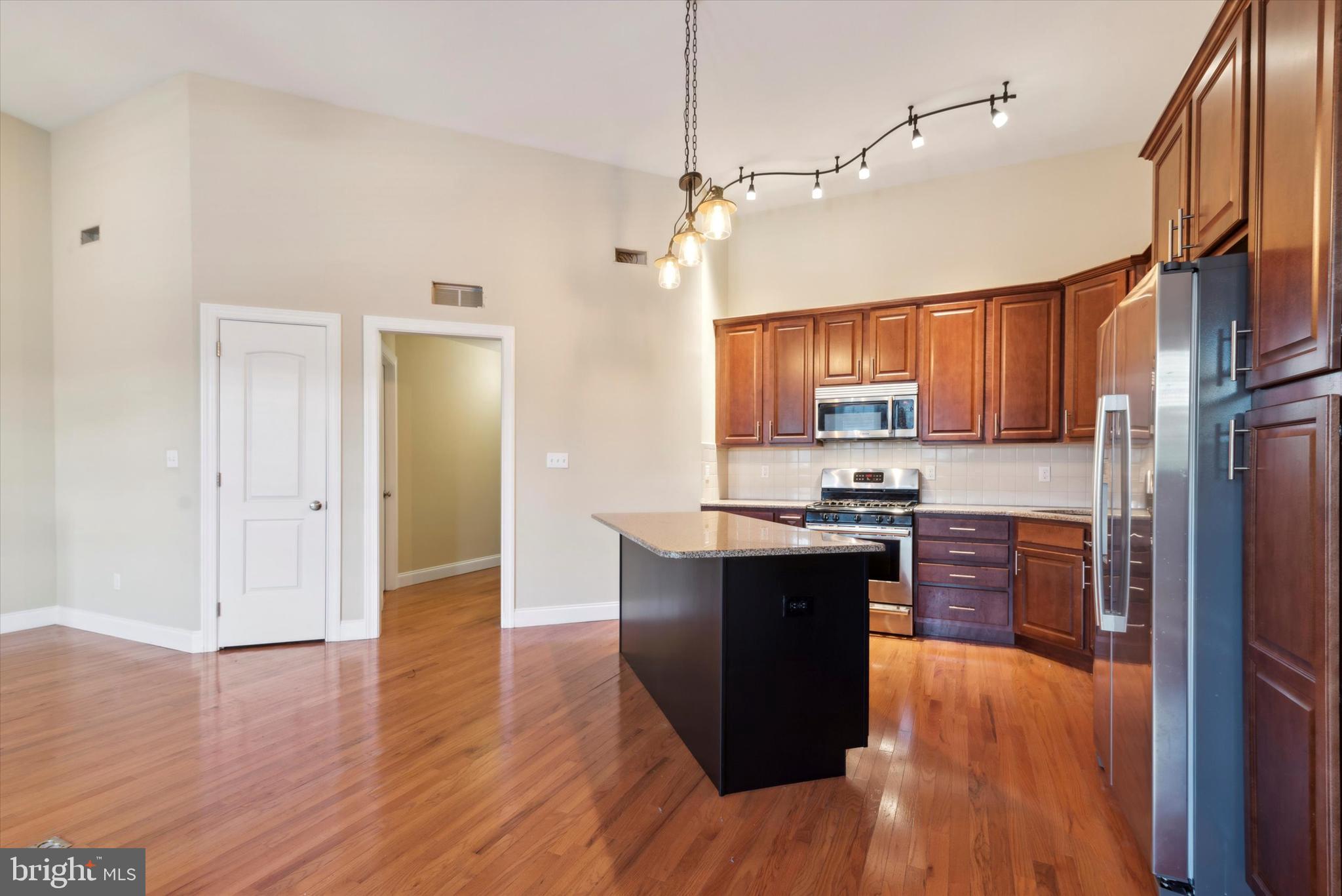4151 Cresson Street, Unit 3F Philadelphia, PA 19127 - Photo 6 of 15 a kitchen with wooden floors and wooden cabinets
