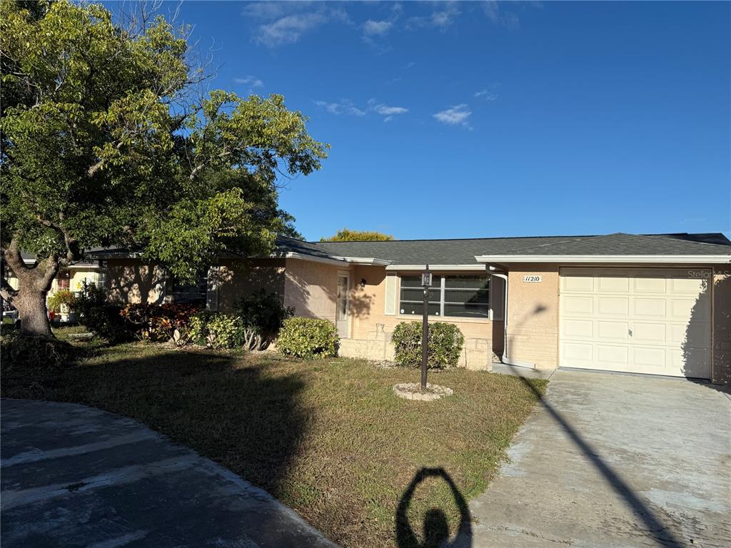 11210 Meadow Drive Port Richey, FL 34668 - Photo 1 of 1 a front view of a house with yard