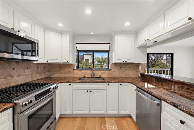 a kitchen with a sink stove and microwave