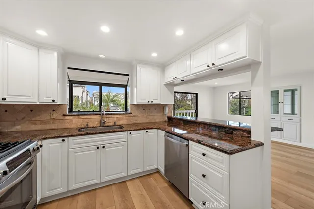 a kitchen that has a sink and a stove in it