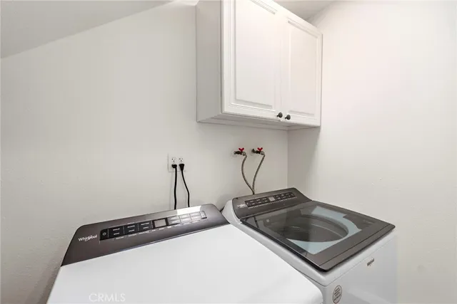 a close view of a sink a stove and cabinets