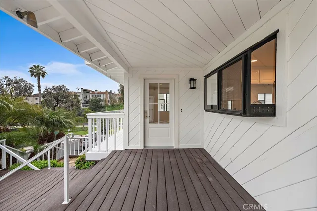 a view of a house with wooden deck