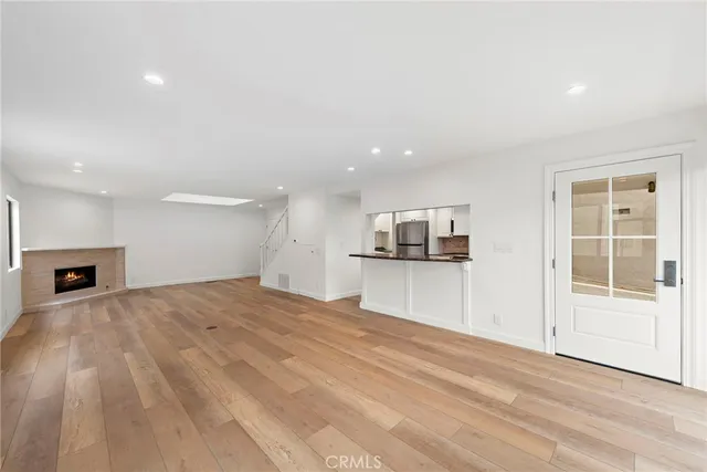 a view of a kitchen with a sink and a refrigerator