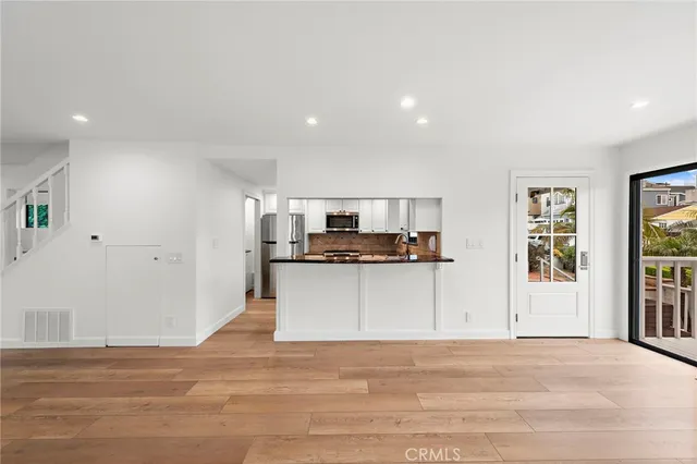 a view of kitchen with cabinets microwave and stove