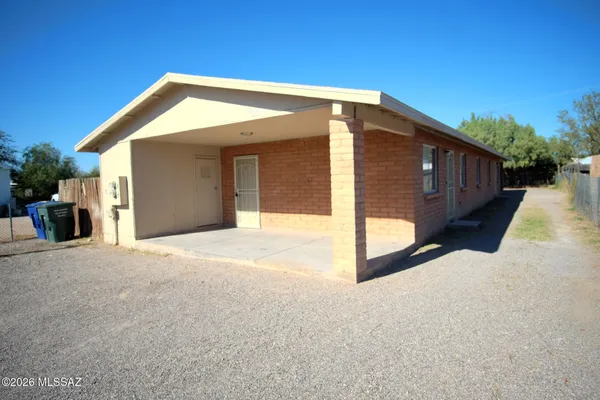 a view of a house with wooden fence and floor