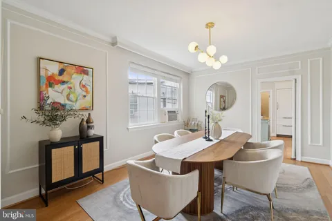 a view of a dining room with furniture a chandelier and wooden floor
