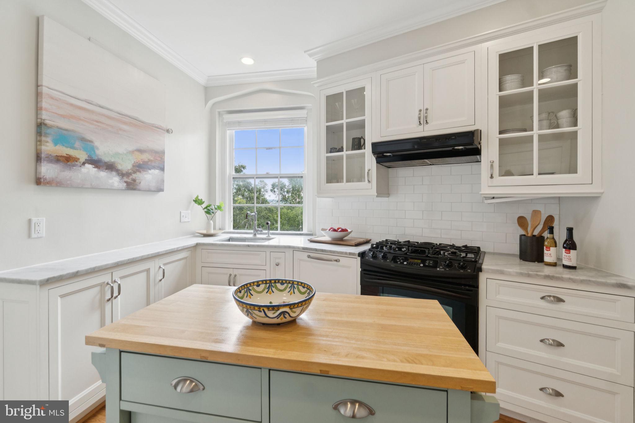 2737 Devonshire Place Northwest, Unit 503 Washington, DC 20008 - Photo 16 of 49 a kitchen with a sink a stove and cabinets